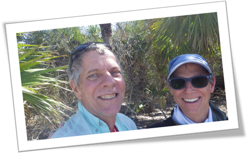 A couple of men taking a selfie

Description automatically generated