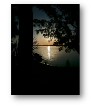 A silhouette of a boat on a lake at night

Description automatically generated