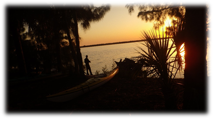 A person standing on a boat next to a body of water

Description automatically generated