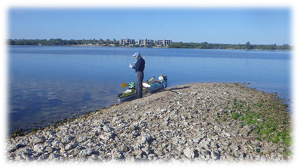 A person standing next to a boat

Description automatically generated