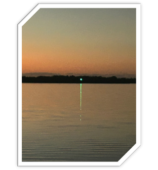 A green laser beam in the sky

Description automatically generated