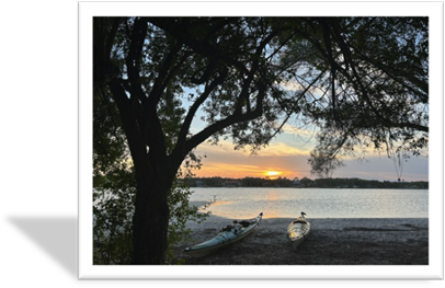 A couple of canoes on a beach

Description automatically generated