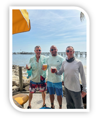 A group of men standing on a beach

Description automatically generated
