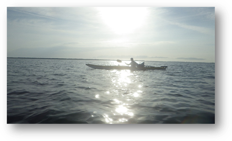 A person in a canoe on the water

Description automatically generated
