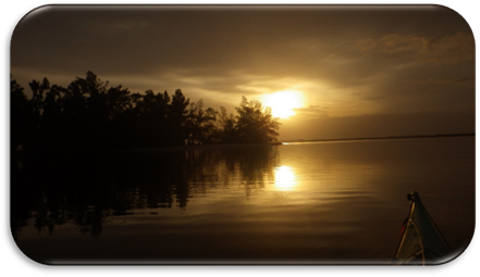 A sunset over a body of water

Description automatically generated
