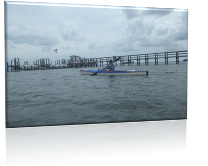 A person in a kayak on the water

Description automatically generated