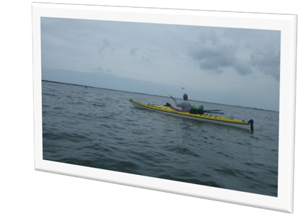 A person in a kayak on the water

Description automatically generated