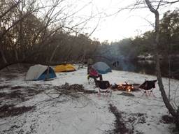A group of people sitting around a campfire in the snow

Description automatically generated with low confidence