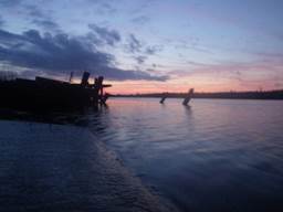 A body of water with a dock and a boat in it

Description automatically generated with low confidence