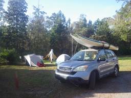 A car with a surfboard on top of it

Description automatically generated